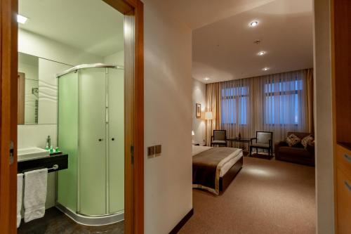 a hotel room with a bed and a bathroom at Zirve Hotel in Shahdag