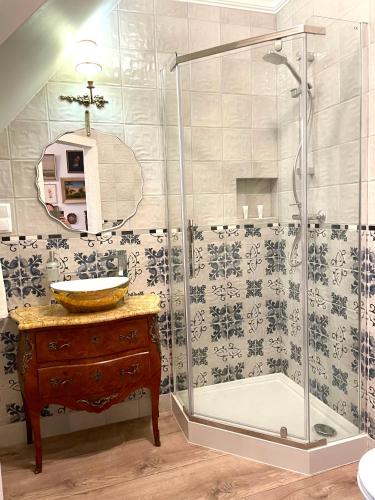 a bathroom with a glass shower and a sink at CHATA OTWARTYCH OKIENNIC Pokoje Gościnne in Supraśl