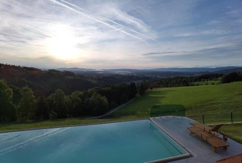 a swimming pool with a view of a hill at Chalet-Südsteiermark - traumhafte Aussicht, Infinity Pool, Privatsphäre, Klima und de-luxe Ausstattung in Schwanberg