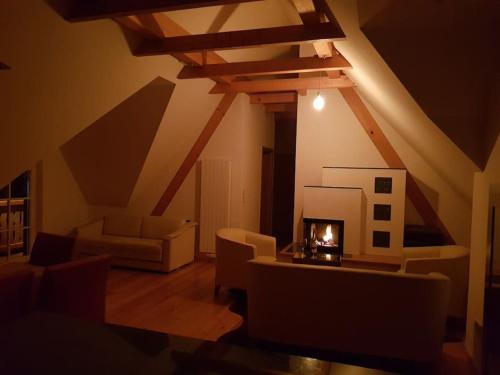 a living room with a couch and a fireplace at Chalet-Südsteiermark - traumhafte Aussicht, Infinity Pool, Privatsphäre, Klima und de-luxe Ausstattung in Schwanberg