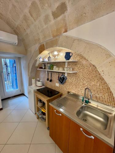 a kitchen with a sink and a counter top at Dimora Aversa in Monopoli