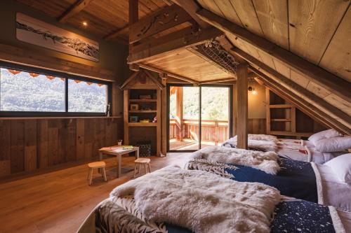 a living room with three couches in a cabin at Chalet de prestige Pyrénéen, 3 min des télécabines in Vignec