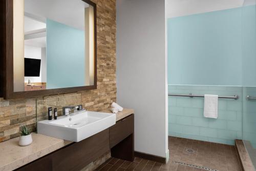 a bathroom with a sink and a mirror at W Scottsdale in Scottsdale