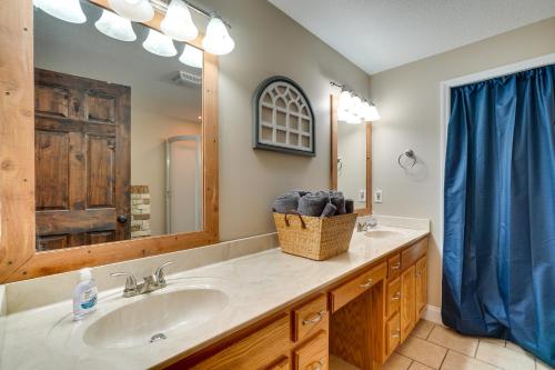 a bathroom with a sink and a mirror at Cozy Tennessee Lake House with Grill and Fire Pit! in Frogue