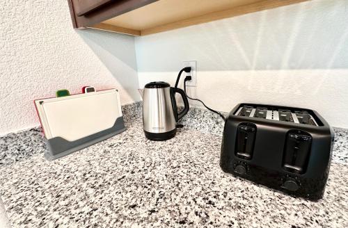 a coffee maker and a toaster sitting on a counter at Spacious House, 5 bedrooms, Sleeps 12, Near Las Vegas Strip and Airport in Las Vegas