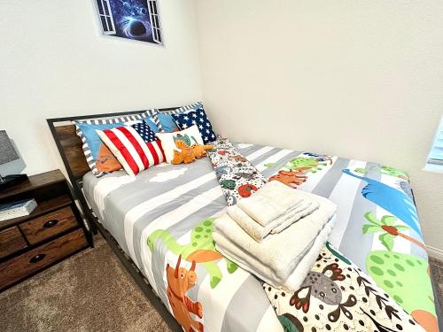 a bedroom with a bed with colorful sheets and pillows at Spacious House, 5 bedrooms, Sleeps 12, Near Las Vegas Strip and Airport in Las Vegas