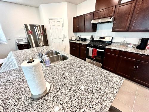 a kitchen with a roll of paper towels on a counter at Spacious House, 5 bedrooms, Sleeps 12, Near Las Vegas Strip and Airport in Las Vegas