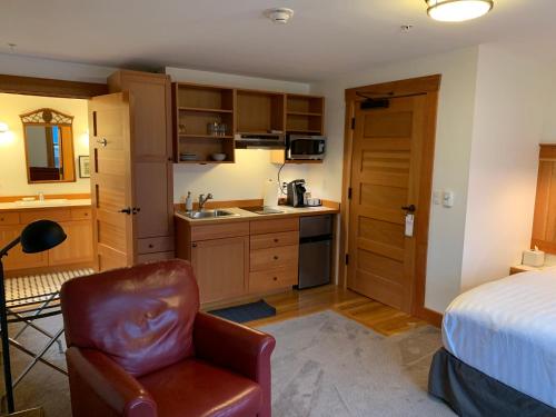 a bedroom with a bed and a chair in a room at Inn At Creek Street in Ketchikan