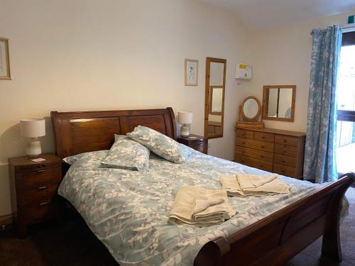 a bedroom with a bed with two towels on it at Wagtail Cottage in Cloughton