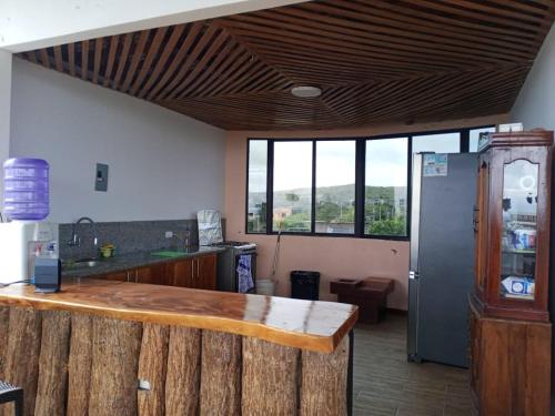 a kitchen with a wooden counter and a large window at Casa D'Lucas in Puerto Baquerizo Moreno