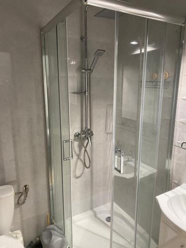 a shower with a glass door in a bathroom at Rajska 14B in Gdańsk