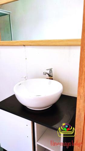 a white sink on a black counter in a bathroom at Uros Maya Lodge in Puno