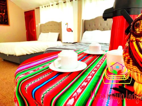 a hotel room with a table with hats on it at Uros Maya Lodge in Puno