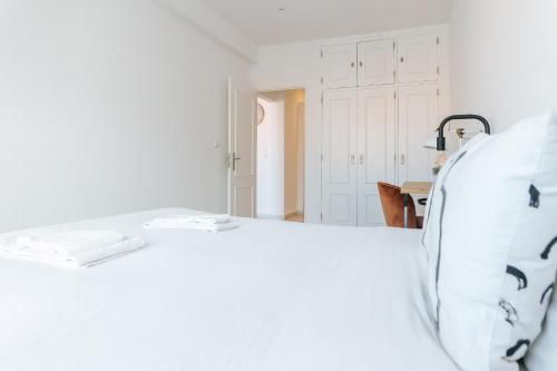 a bedroom with a white bed with two towels on it at Lisboa - Almirante Reis Central Apartment in Lisbon