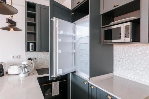 a kitchen with a refrigerator and a microwave at Lisboa - Almirante Reis Central Apartment in Lisbon