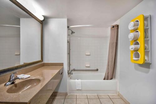 a bathroom with a sink and a shower and a tub at Motel 6-Lafayette, LA in Lafayette