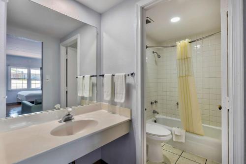 a white bathroom with a sink and a toilet at Motel 6-Falls Church, VA - Arlington Boulevard in Falls Church