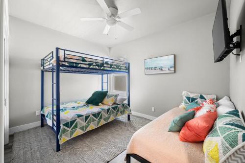 a bedroom with two bunk beds and a ceiling fan at Beautiful New 3 Bedroom Townhouse w/ Private Pool in Corpus Christi