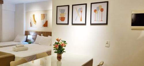 a hotel room with a bed and a table with flowers at BSB Stay Premium - Flats Particulares - SHN in Brasilia