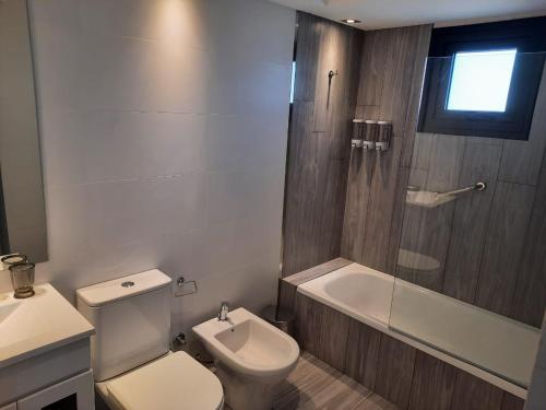 a bathroom with a toilet and a shower and a sink at In House BA - Le coq in Buenos Aires