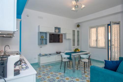 a kitchen and living room with a table and chairs at Casa Sammarco in Minori