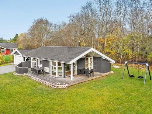 a small house with a porch and a swing at 6 person holiday home in Silkeborg in Silkeborg