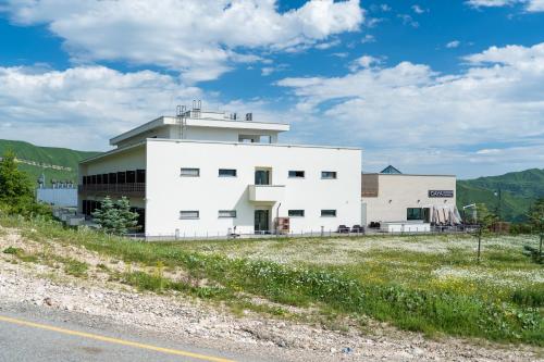 a white building on the side of a road at Gaya Residences in Shahdag