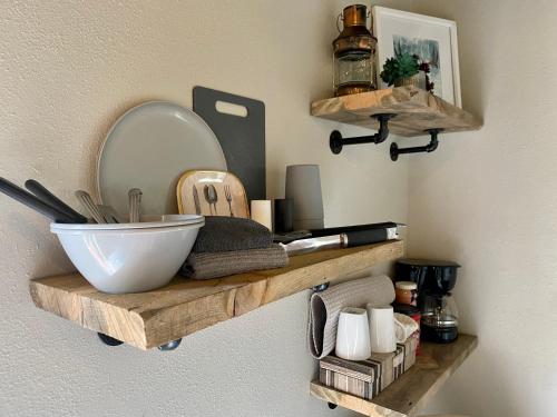 a shelf with a mirror and a bowl on a wall at Cabin 7 at Horse Creek Resort in Rapid City