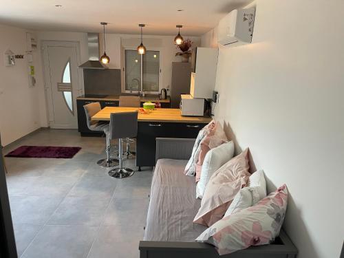 un salon et une cuisine avec un canapé et une table dans l'établissement Petite maison climatisée, à Bonneuil-sur-Marne