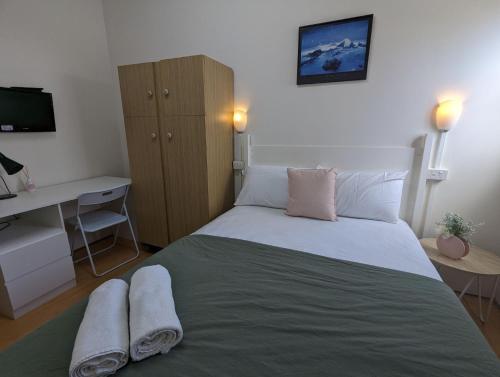 um quarto com uma cama com duas toalhas em Studio 19 Wright Lodge em Adelaide