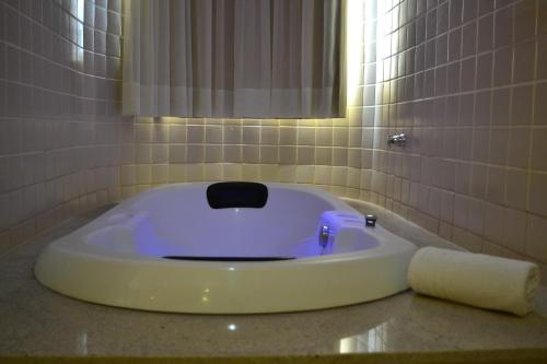 a bath tub sitting on a counter in a bathroom at Hotsprings Suite Hotel in Caldas Novas