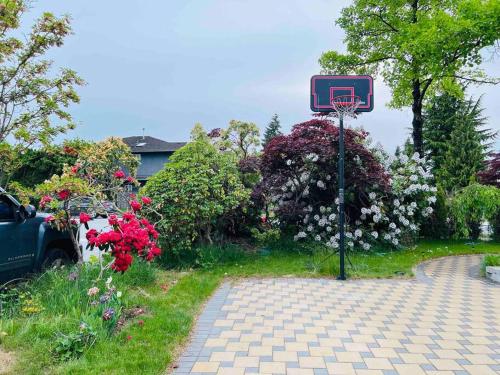 a basketball hoop in the middle of a driveway at All-ways Home in Burnaby