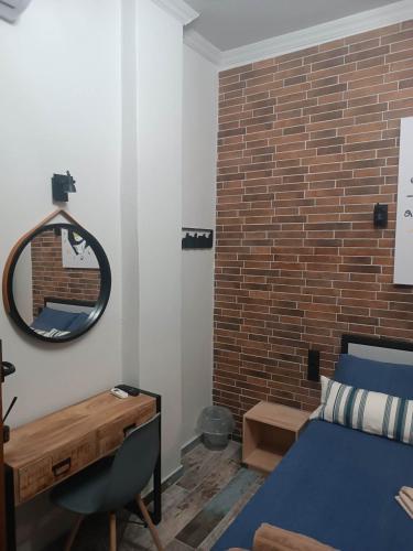 a bedroom with a blue bed and a mirror at Grecos STAY SKIATHOS in Skiathos Town