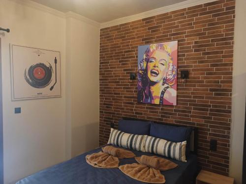 a bedroom with a brick wall and a bed at Grecos STAY SKIATHOS in Skiathos Town
