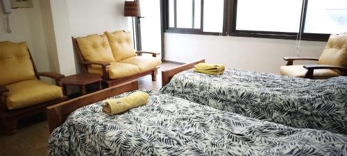 Habitación con 2 camas y 2 sillas en Piso Completo en Nueva Córdoba, en Córdoba