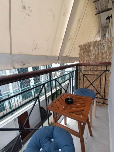 a room with a table and chairs on a balcony at Grecos STAY SKIATHOS in Skiathos Town
