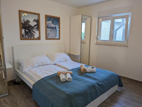 a bedroom with a bed with two stuffed animals on it at Apartment LIPA in Vir