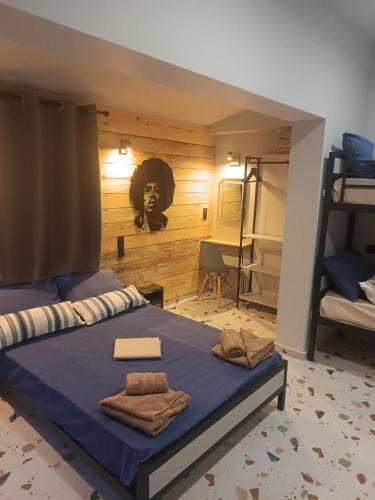 a bedroom with a bed with towels on it at Grecos STAY SKIATHOS in Skiathos Town