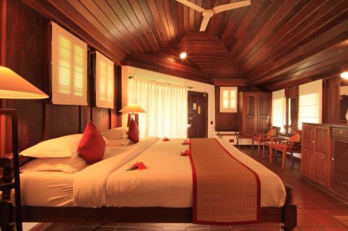 a bedroom with a large bed in a room at Coconut Lagoon Kumarakom - A CGH Earth Experience in Kumarakom