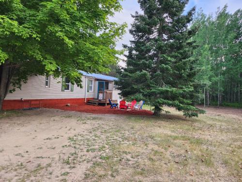 a house with a pine tree in the yard at Mi-o My Getaway in Mio