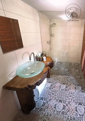 a bathroom with a sink and a shower at Chatka pod lesom in Banská Štiavnica