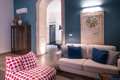 a living room with a couch and a chair at Palazzo Gilistro in Siracusa