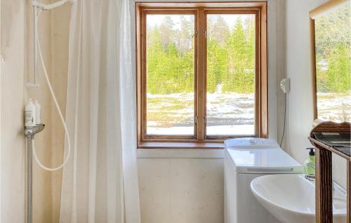 ein Bad mit einem Waschbecken, einem WC und einem Fenster in der Unterkunft 3 Bedroom Awesome Home In Nybofjll 
