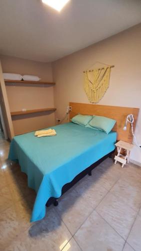 a bedroom with a blue bed in a room at Studio Aurora - Recife in Recife