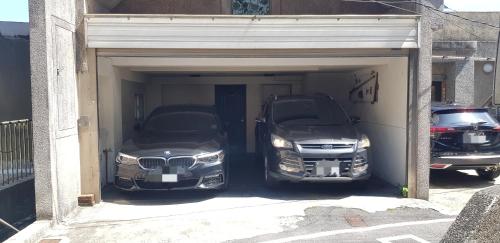 two cars are parked in a garage at Slowly B&B in Jiufen