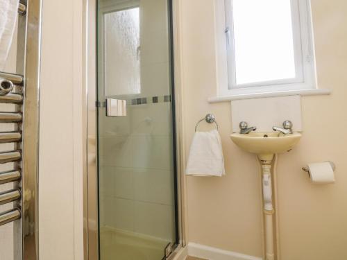 a bathroom with a sink and a shower at Pentewan in Hayle