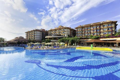 a large swimming pool in front of a hotel at Adalya Art Side - Ultra All Inclusive in Side