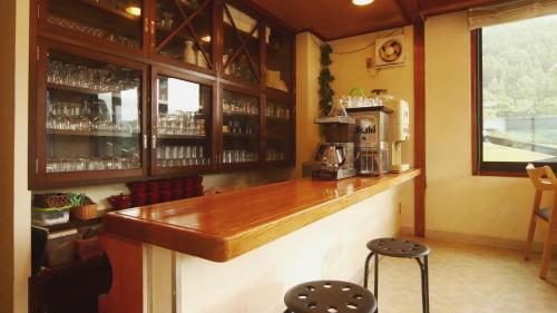 a bar in a restaurant with a coffee maker at Chalet Nozawa in Nozawa Onsen