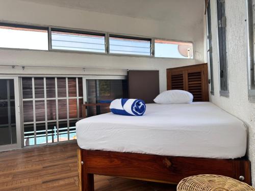 a large bed in a room with a window at bacalar My Love Front Laguna in Bacalar