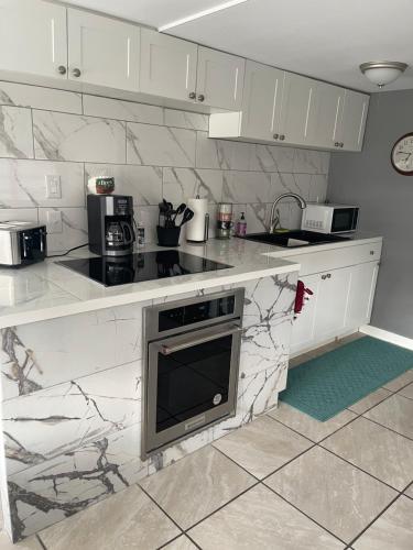 a kitchen with white marble counter tops and appliances at Home in Arbor Terrace Resort in Bradenton